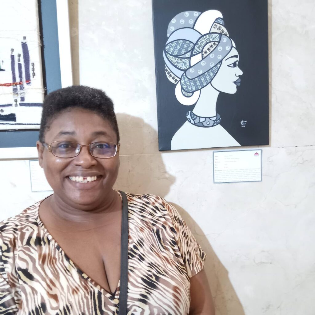 Halcian Pierre at the Rotunda Gallery next to her painting She Walks in the Shadows. - 