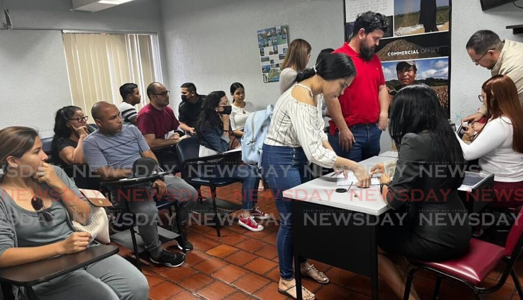 A group of Venezuelans collect their passports at the Venezuelan embassy, Victoria Avenue, Port of Spain on Friday. - Photo by Grevic Alvarado