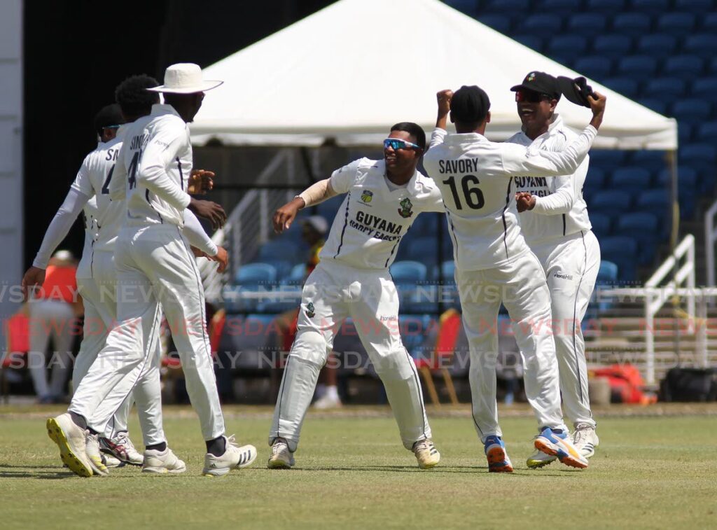 Guyana Harpy Eagles teammates celebrate their 143-run win against the TT Red Force, on Saturday, during the CWI Regional Four Day Championship round three match, at the Brian Lara Cricket Academy, Tarouba. - Lincoln Holder
