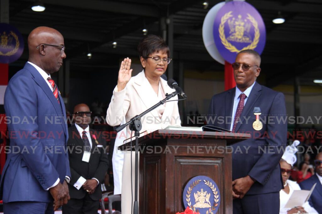 Her excellency Christine Kangaloo, the seventh President of the Republic of Trinidad and Tobago, takes the oath of office alongside Prime Minister Dr Keith Rowley and Chief Justice Ivor Archie at the presidential inauguration held at the Queen's Park Savannah in Port of Spain. - Photo by Ayanna Kinsale