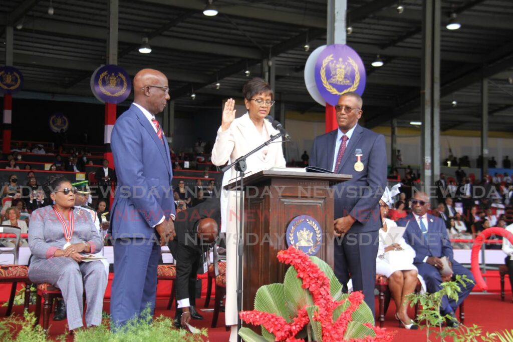 I SWEAR: Christine Kangaloo takes the oath as TT's seventh President on Monday at Queen's Park Savannah, Port of Spain, between Prime Minister Dr Keith Rowley and CJ Ivor Archie, right. Seated at left is immediate former president Paula-Mae Weekes. PHOTO BY AYANNA KINSALE - 
