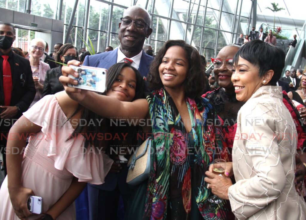 Zalia Robinson-Regis takes a selfie with her sister Sarai, Prime Minister Keith Rowley, mothe Camille Robinson-Regis, and Sharon Rowley during the reception following at NAPA, Frederick Street, Port of Spain. - Ayanna Kinsale