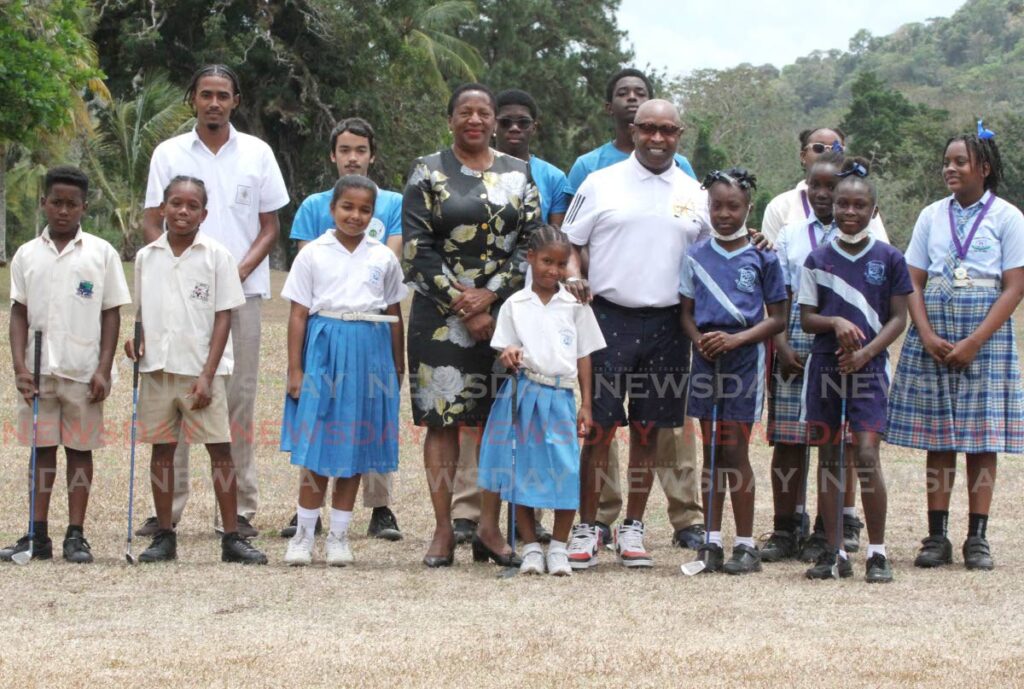 Planning and Deve lopment Minister  Pennelope Beckles, centre, and Professor Frank Fraley, centre right, are joined by participants of the  Chaguaramas  Development Autho- rity’s junior golf clinic at the Chaguaramas golf course, Chaguaramas, on Wednesday. - Ayanna Kinsale