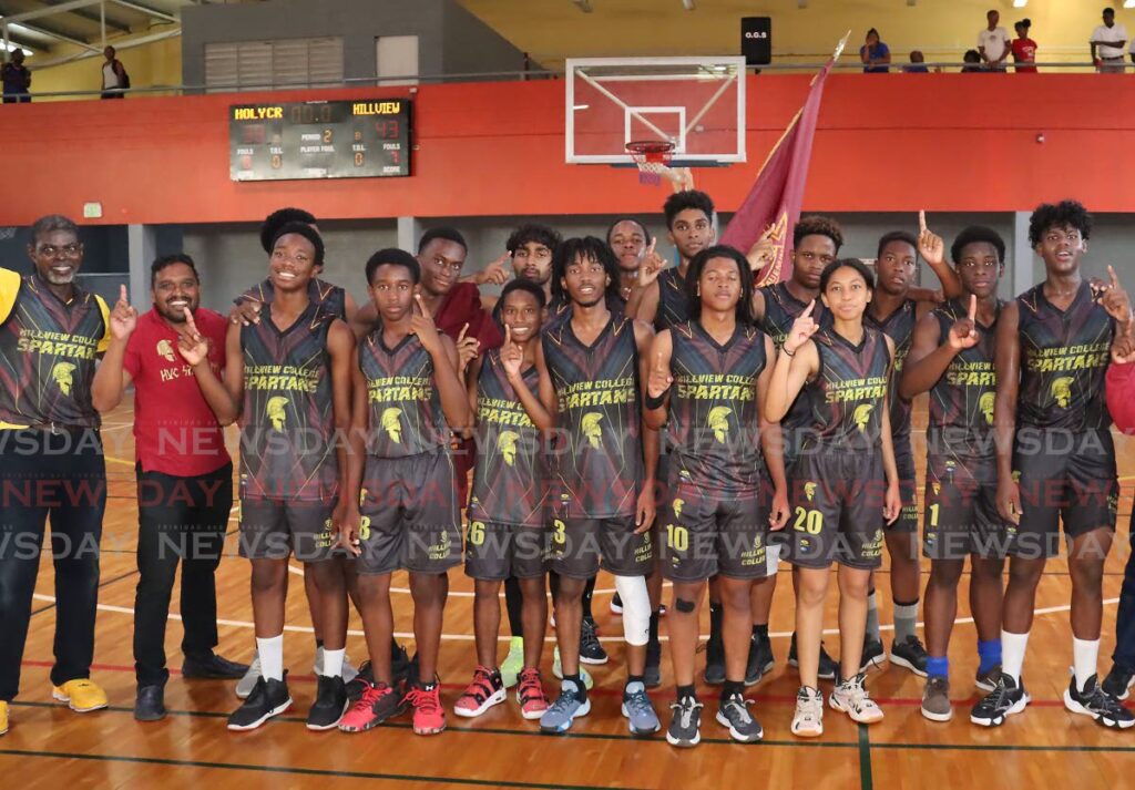 Hillview College under-20 players and staff celebrate victory in the Secondary Schools Basketball League at the Maloney Indoor Arena, Friday. - Photo by Roger Jacob