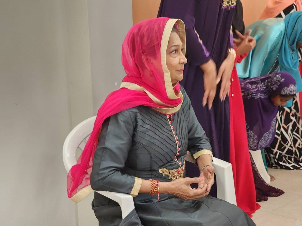 PRAYERS: Opposition Leader Kamla Persad-Bissessar prays during Iftar (breaking of the day's fast for Ramadan) at the Chaguanas Borough Corporation office on Saturday. PHOTO COURTESY OFFICE OF THE OPPOSITION LEADER -