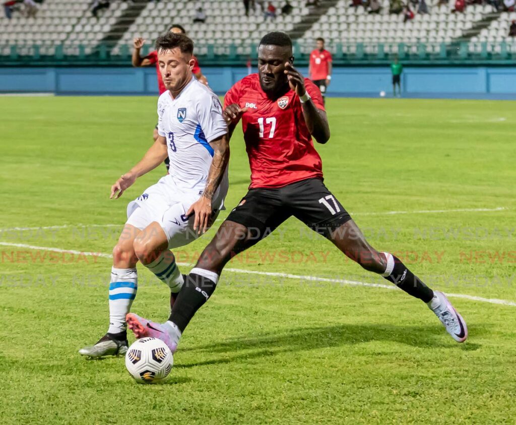 TT's Rundell Winchester (R) vies for possession during the Concacaf Nations League match, on Monday, against Nicaragua, at the Dwight Yorke Stadium, Bacolet. - David Reid