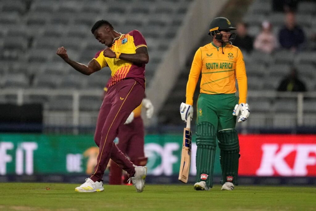 West Indies bowler Alzarri Joseph, left, celebrates after dismissing South Africa's batsman Quinton de Kock during the final T20 match, at Wanderers stadium, in Johannesburg, South Africa, Tuesday. - AP