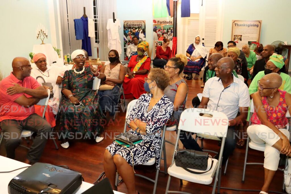 The audience listens attentively as Pastor Ingrid Ryan-Ruben answers questions from audience members at the National Trust's public discussion on Spiritual Baptist Ancient Landmarks held at Mille Fleurs, Maraval Road, St Clair on March 28.  - ROGER JACOB
