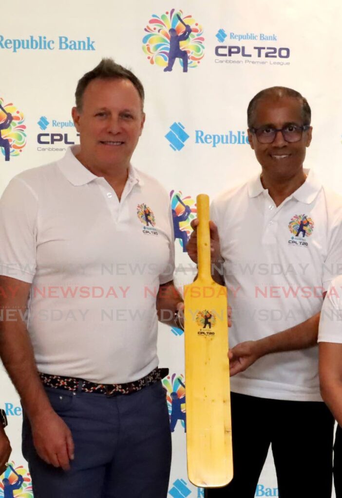 CPL CEO Pete Russell, left, holds a bat with Republic Bank managing director Nigel Baptiste, at a press conference at the Queen's Park Oval, Port of Spain on Wednesday to announce the bank as CPL's title sponsor. - Photo by Roger Jacob