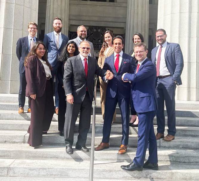 Former attorney general Faris Al-Rawi, TT's representative in Miami, celebrate with the State's legal team from the Miami law firm White & Case at the Miami-Dade County Courthouse at 73 West Flager Street, Miami, on Wednesday. - 