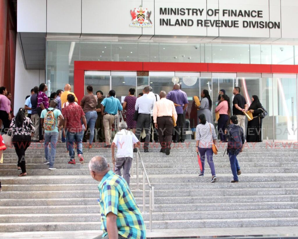 Members of the public wait to enter the Inland Revenue Division of the Ministry of Finance, Port of Spain in December, 2019.  - ANGELO MARCELLE