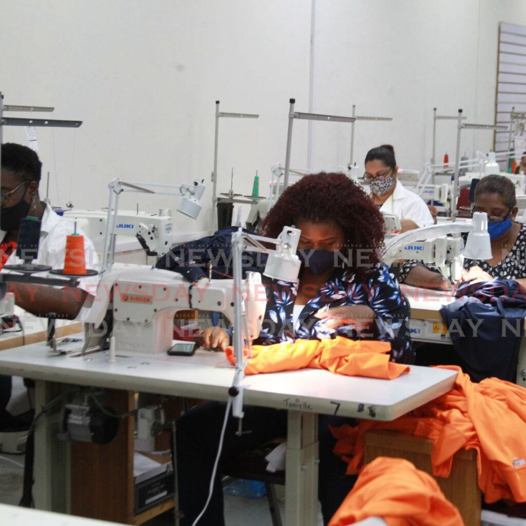 Employees of Lazuri Apparel, at their seamstress' stations on the factory floor. Photo by Roger Jacob