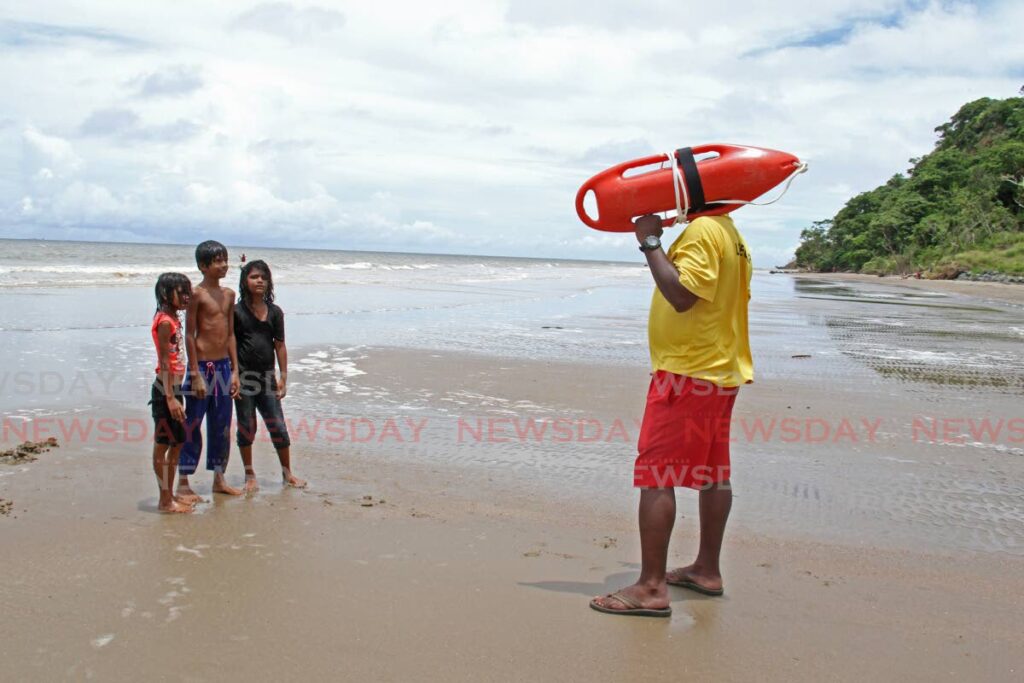 in this file photo, a lifeguard give advice to some children at Quinam beach.  - Marvin Hamilton