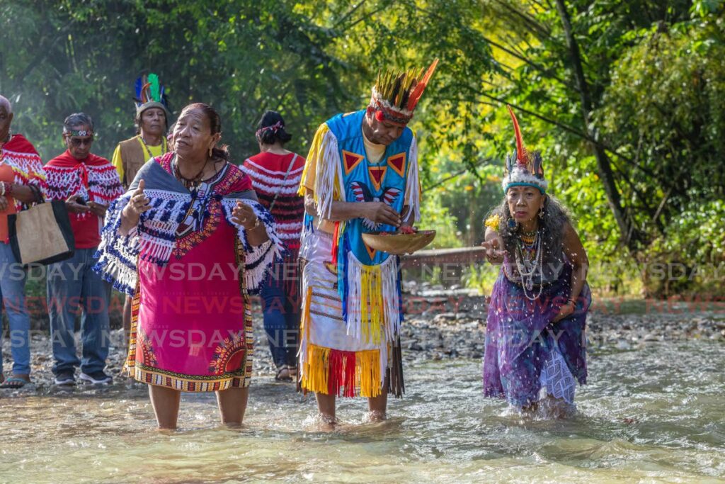 In this file photo, Suriname Shaman Anesta Jagendorst, Santa Rosa First Peoples Chief Ricardo Bharath Hernandez and Queen Nona Lopez Calderon Galera Moreno Aquan make offerings after paying respects and saying a personal prayer during the First Peoples River Ritual at the Arima River, Blanchisseuse Road, Arima in 2022.  - JEFF K MAYERS