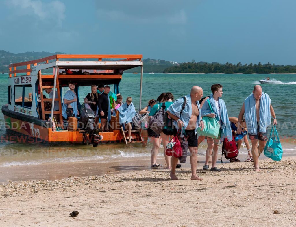 Tourists disembark the First Try glass-bottom boat after a tour of Buccoo Reef, Tobago after arriving on the island on a cruise ship. - File photo