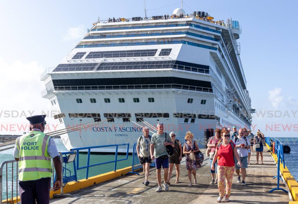 FILE PHOTO: Tourists disembark a cruise ship at the Port of Scarborough.