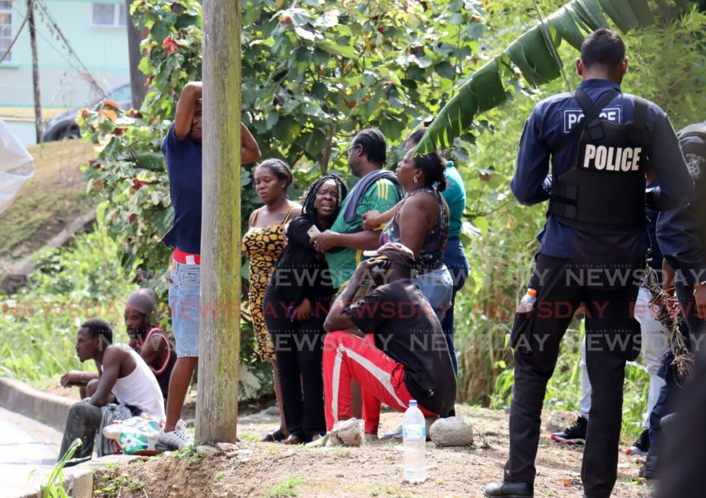 Relatives grieve for Brandon Victor who was gunned down at a construction site, Upper Cascade Main Road, St Ann's on March 10. - ROGER JACOB