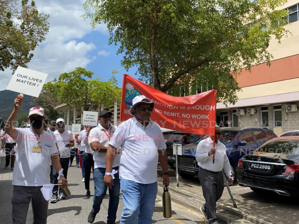 ON THE GO: WIGUT members during one of their many protests at The UWI's St Augustine campus. The action is over stalled wage negotiations. PHOTO BY NARISSA FRASER - 