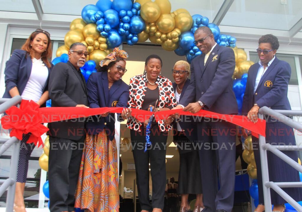 Minister of Planning and Development Pennelope Beckles-Robinson, centre, and president Vernly Gift, right cut the ribbon with other officials at the opening of the Police Credit Union on Green Street, Arima on April 1. - AYANNA KINSALE