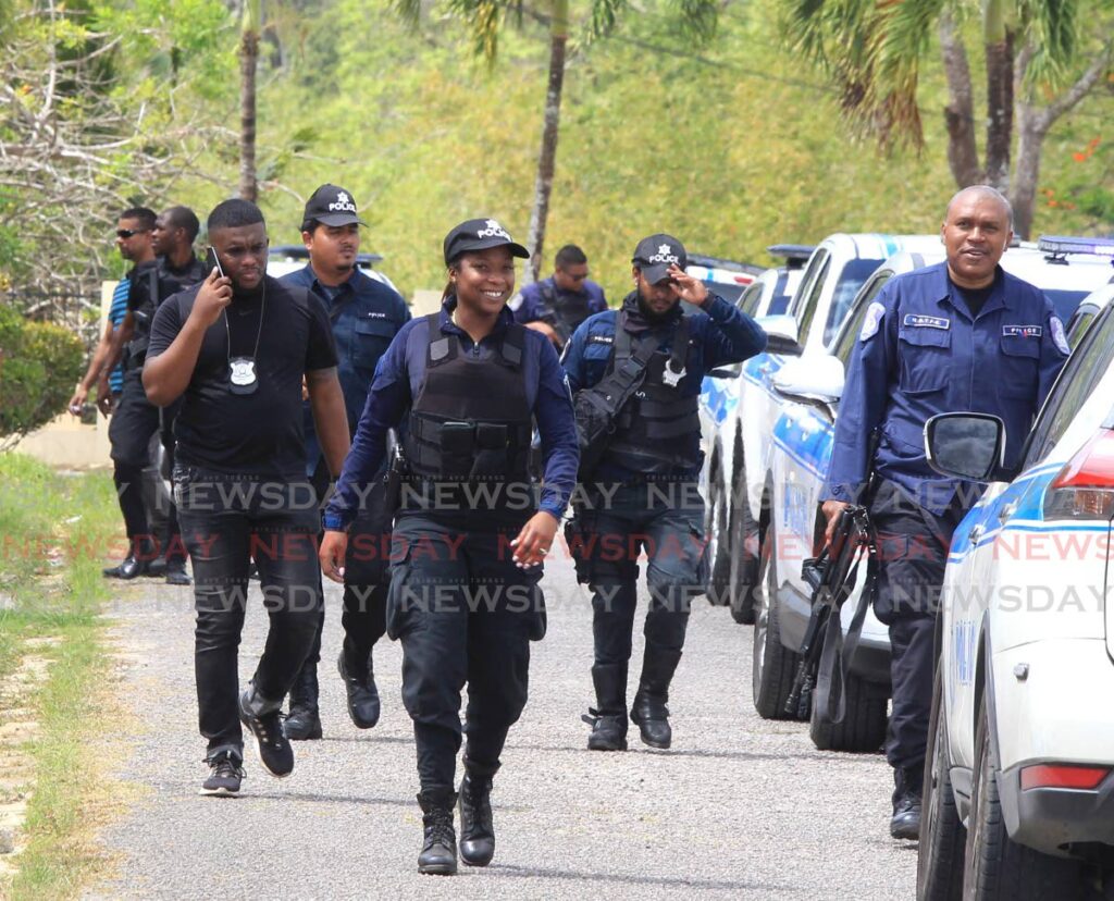 CRIME SCENE: Officers at the scene of a robbery and kidnapping Ridgeland Park of the Arima Old Road on Sunday.  - Photo by Ayanna Kinsale