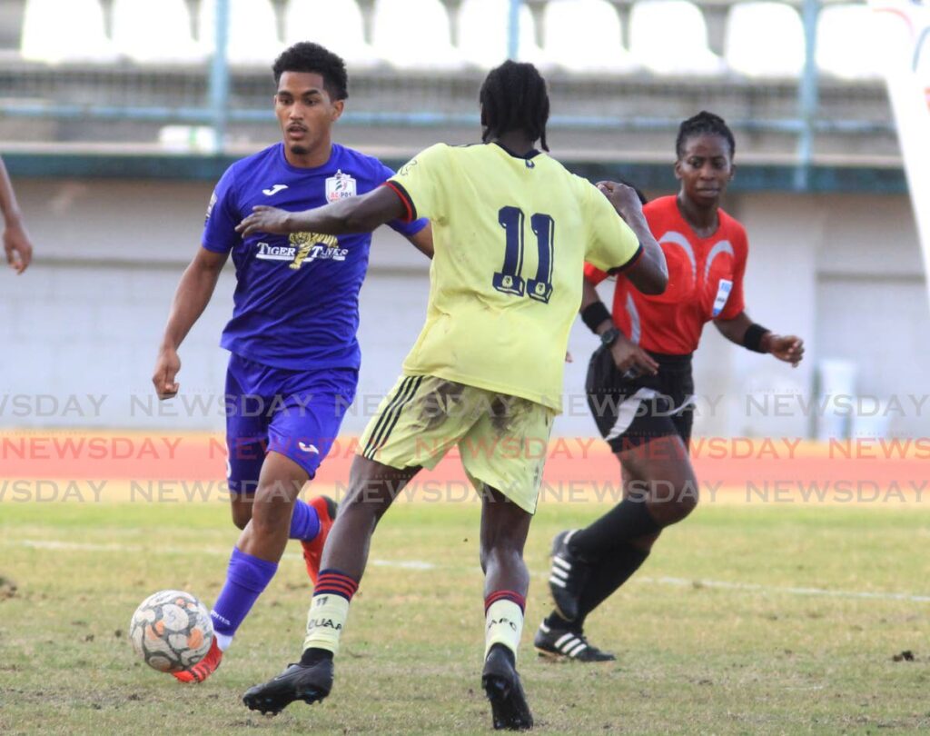 AC Port of Spain's Michel Poon-Angeron looks to make a play as Cunupia FC's Miguel Williams defends during a TT Premier Football League match, at the Larry Gomes Stadium, Malabar, on Saturday.  - AYANNA KINSALE