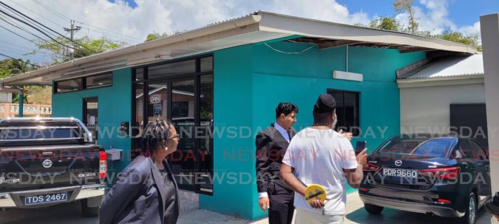 Justice Frank Seepersad, centre, visited the property at the middle of a dispute between relatives in  Carnbee, Tobago, on Monday.  - 