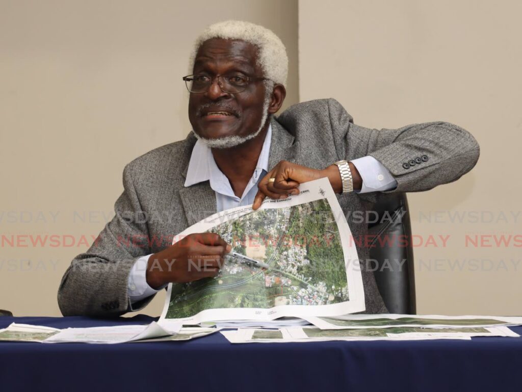 NIDCO chairman Herbert George shows off a geographical map of a planned construction project during a press conference on Monday at the Ministry of Works and Transport in Port of Spain. PHOTO BY ROGER JACOB - 