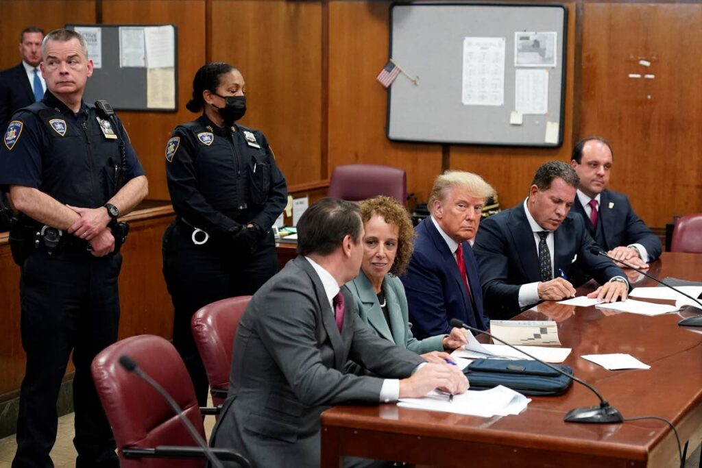 IN COURT: Former US President Donald Trump, seated centre, with his legal team in the New York courtroom where he was arraigned on a 34-count criminal indictment, all of which he pleaded not guilty to. AP PHOTO - 