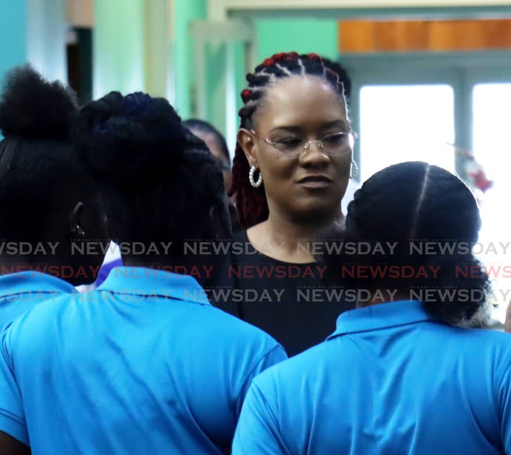 INTERACTION: Minister in the Office of the Prime Minister Ayanna Webster-Roy interacts with wards of the St Jude's Home for Girls during the launch of a training programme on Tuesday at Webster-Roy's office in St Clair. PHOTOS BY ROGER JACOB - 