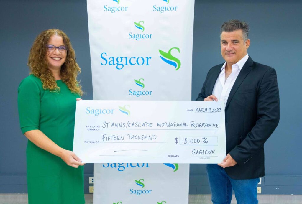 Trisha Davis, assistant vice president, process optimisation and analytics, Sagicor Life Insurance (Trinidad & Tobago) Ltd presents Dwayne Henderson, chairman of the St Ann’s/Cascade Motivational Programme with a cheque at the insurer’s head office in Port of Spain. - 