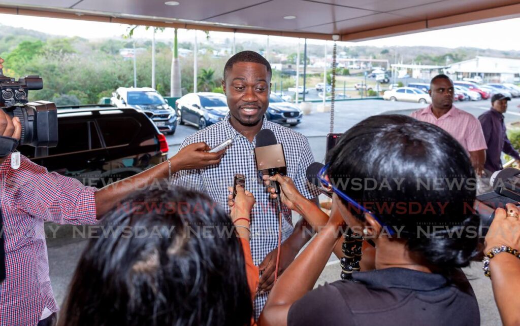 Chief Secretary Farley Augustine, centre, speaks to media at a meeting attended by 13 THA executive members and their supporters at the Shaw Park Cultural Complex on Tuesday. The meeting was held to discuss the formation of a new party to be led by Augustine. - David Reid