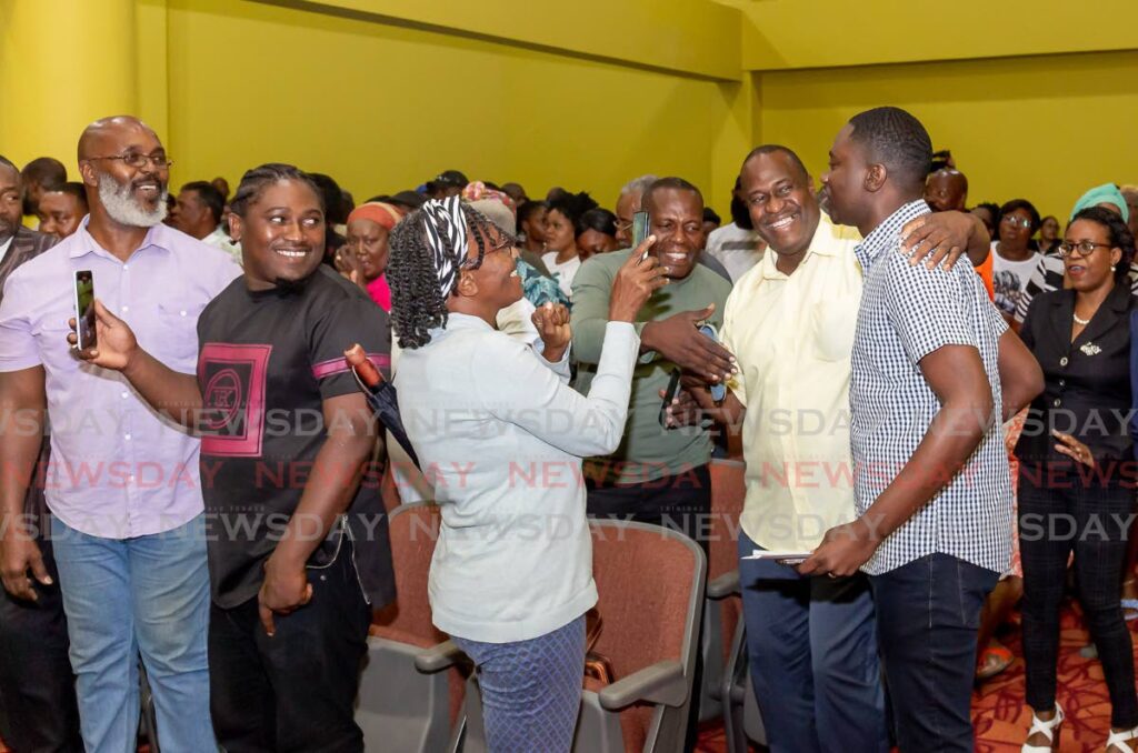 Chief Secretary Farley Augustine is warmly greeted by supporters during a meeting to discuss the formation of a new political party at Shaw Park Cultural Complex on Tuesday. - David Reid