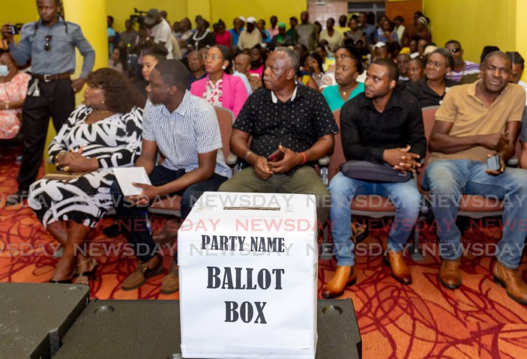 Chief Secretary Farley Augustine, second from left, listens with supporters to speakers at Shaw Park Cultural Complex, Tobago, on April 4, where a ballot box was placed to collect names for a new political party. - David Reid