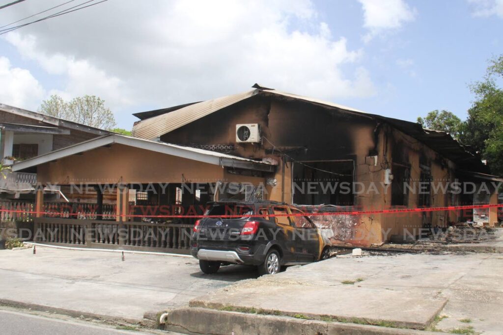 DAYS LATER: The burnt house in Quinam Road, Siparia on Wednesday, three days after the fire claimed the lives of a 42-year-old woman and her eight-year-old daughter. PHOTO BY MARVIN HAMILTON - 