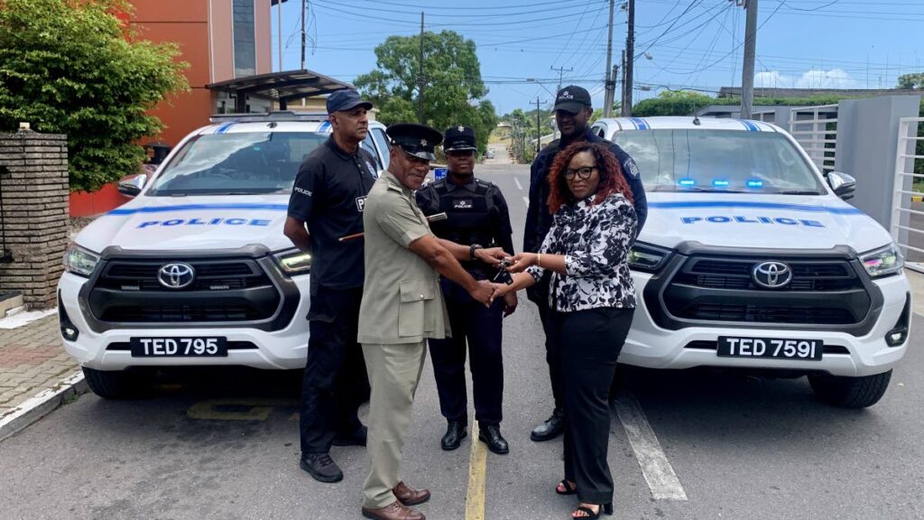 Donnamay Taylor (right) presents the keys to two new vehicles to the head of the Point Fortin municipal police, acting supt Ayoung. - Point Fortin Borough Corporation