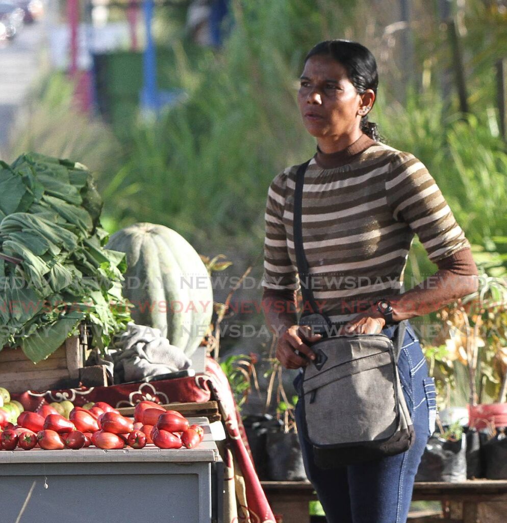 LOST HER SON: Helen Riley near the vegetable stall she and her son Daniel operate near their home in Freeman Road, St Augustine. Her son was gunned down on Wednesday. PHOTO BY ANGELO MARCELLE - 