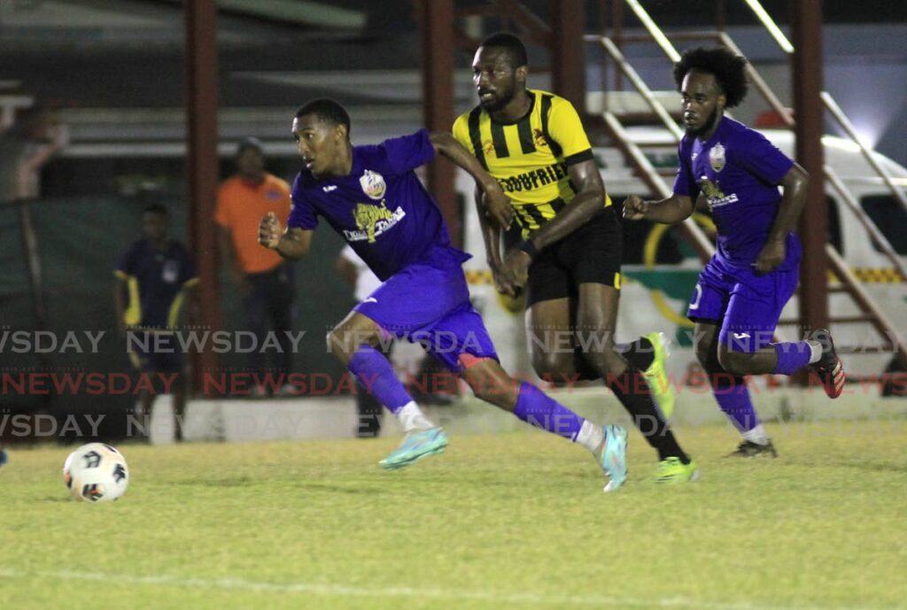 AC Port of Spain's John-Paul Rochford, left, on the attack against  Central FC during the TT Premier Football League at the La Horquetta Grounds, La Horquetta, Wednesday.  - AYANNA KINSALE
