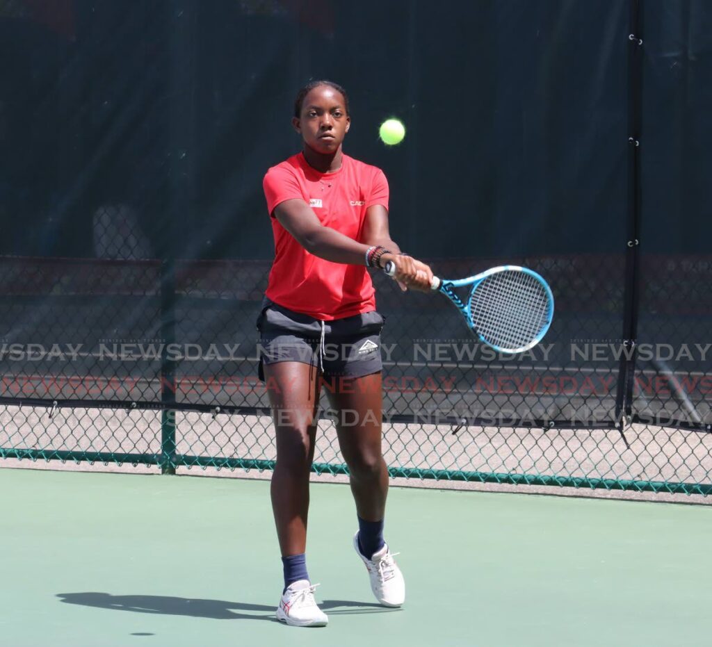 WINNER: Gabriella Prince plays a shot against Madison Khan on Thursday in the Girls U14 final of the Catch Junior Tennis Championships on Thursday at the National Racquet Centre in Tacarigua. Prince eventually won 6-1 6-3. PHOTO BY ROGER JACOB - ROGER JACOB