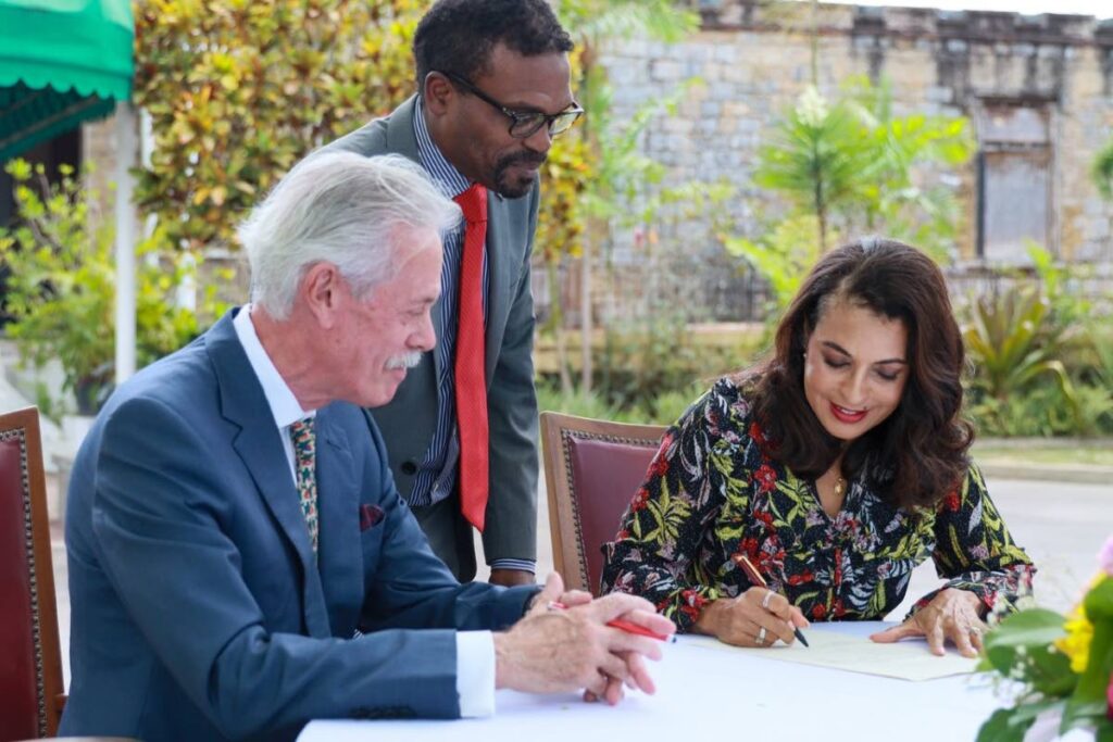 US Ambassador to TT Candace Bond (right) signs an agreement to acquire property at Maraval, including the Trinidad Country Club,  for the construction of a new US Embassy. Looking on are Joseph Fernandes (left) representative of Champs Elysees Ltd  (the former owner of the  property, and US State Dept official Christin Martinelli.
 - Photo courtesy of the US Embassy