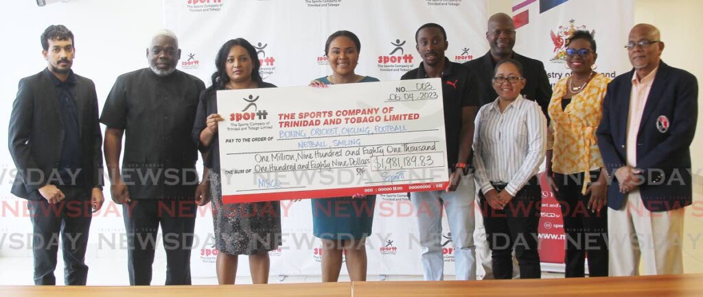 CHEQUE OUT: Sport Minister Shamfa Cudjoe, centre, holds the cheque for $1.9m as she and heads of the six national governing bodies and SporTT pose for a photo on Thursday at the National Aquatic Centre in Balmain Couva. PHOTO BY LINCOLN HOLDER - Lincoln Holder