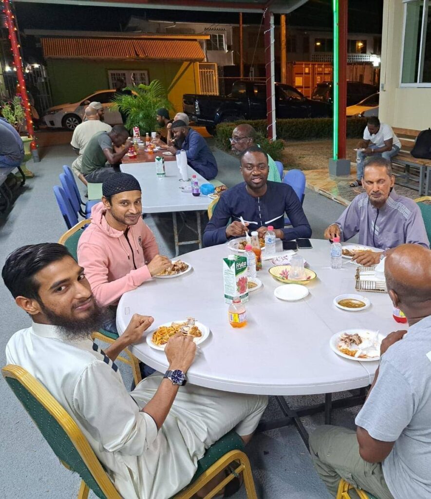 Chief Secretary Farley Augustine shares a meal with members of the Muslim community last week at the Lowlands mosque. Photo courtesy Kameel Ali, head of the Tobago Muslim Organisation. - 