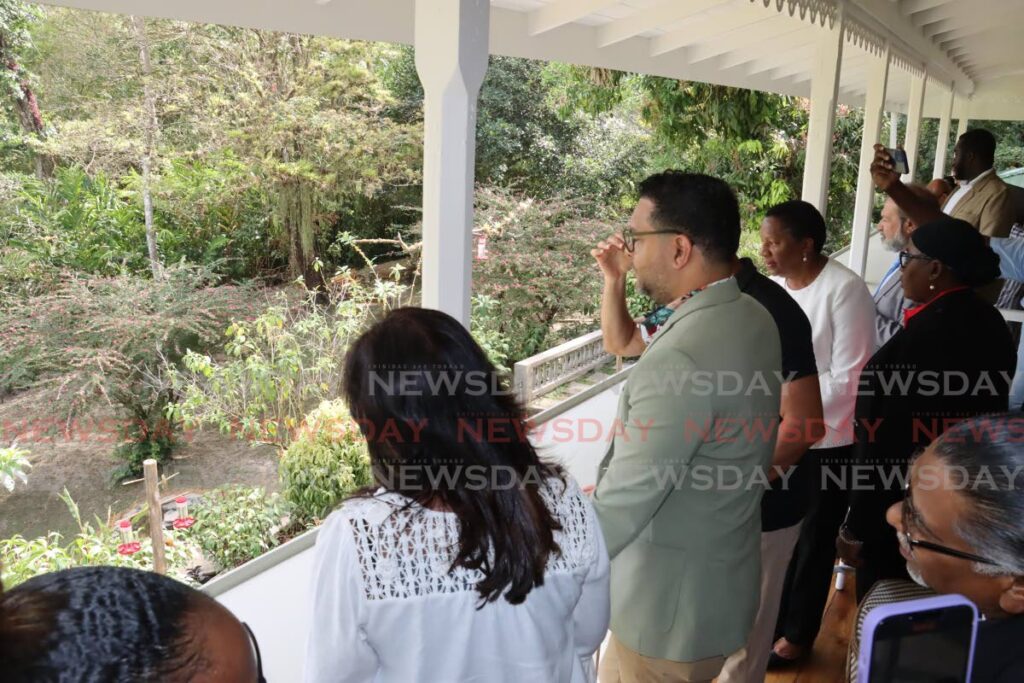 Tourism Minister Randall Mitchell and other guests look out to the Arima Valley from the main viewing veranda at the re-opening of the Asa Wright Nature Centre on April 6. - ROGER JACOB
