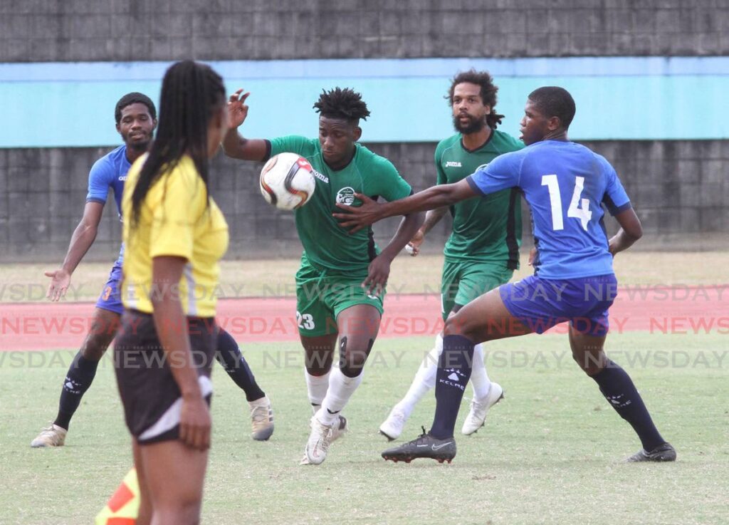 W Connection's Prince Pascall goes past Club Sando's Josiah Cooper at the Manny Ramjohn Stadium, Marabella on Saturday.  - Photo by Angelo Marcelle