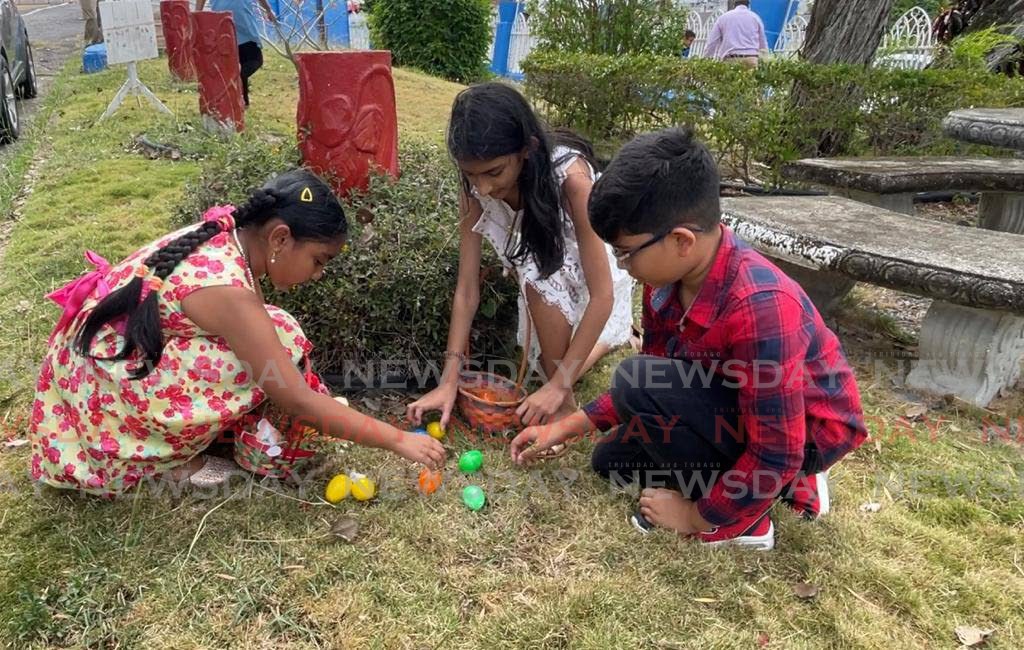 Children hunt for Easter eggs in the yard of the Susamachar Presbyterian Church on Easter Sunday. - Yvonne Webb