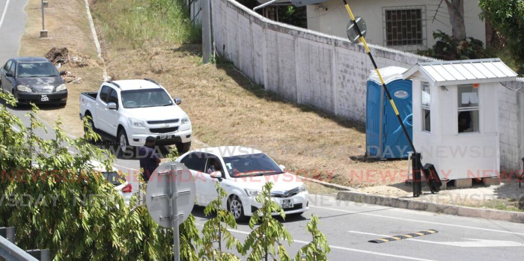 A security officers checks drivers entering Valsayn South on April 14. The residents took action to screen people entering their community after a series of crimes, including home invasions.  - ANGELO MARCELLE