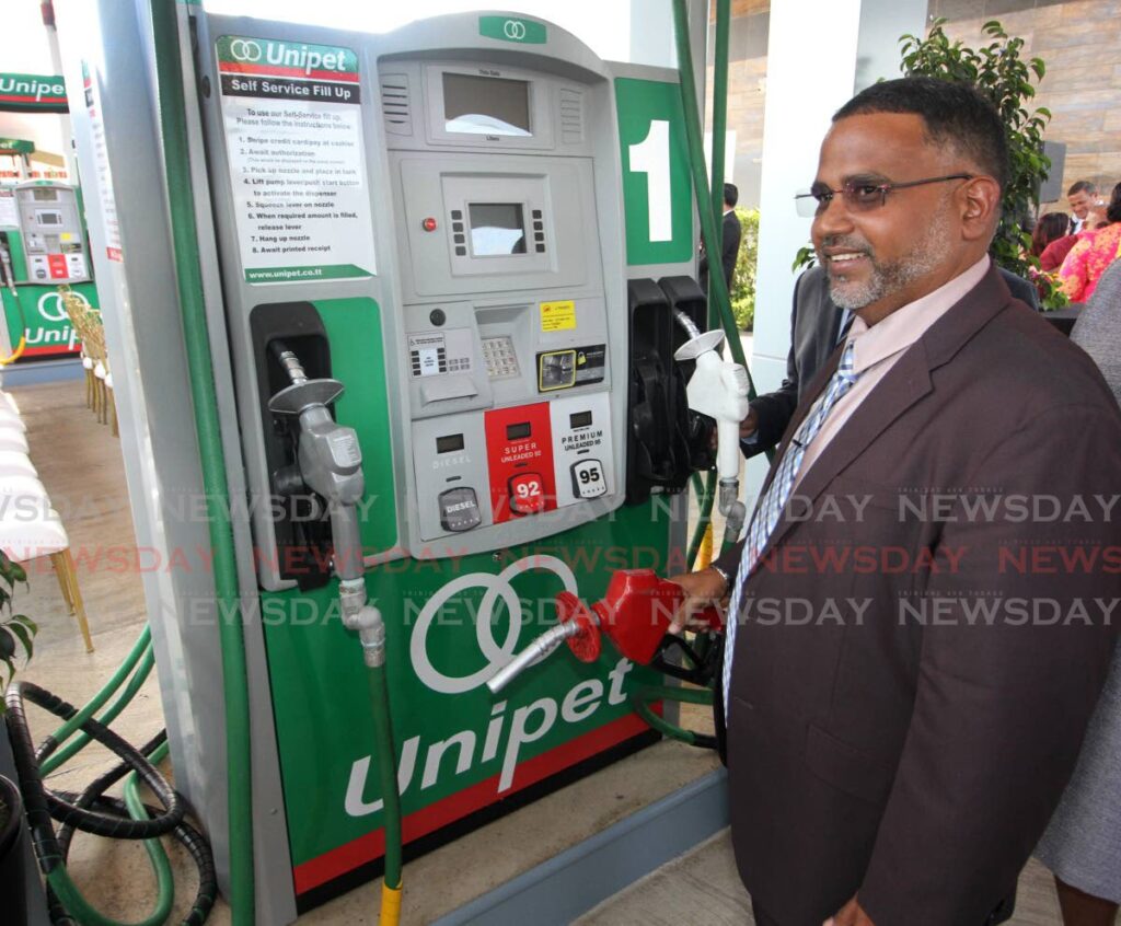 Unipet service station operator Reval Chattergoon holds a pump at its launch, corner of Ramgoolie Street and Southern Main Road, Curepe on Wednesday. The station opens on April 17. - ANGELO MARCELLE