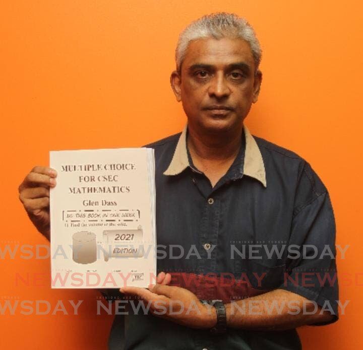  Kishwar Dass, aka Glen Dass with a copy of one of his books. Dass  is offering free PDF books to help CSEC students  with their studies to improve their grades. - Lincoln Holder