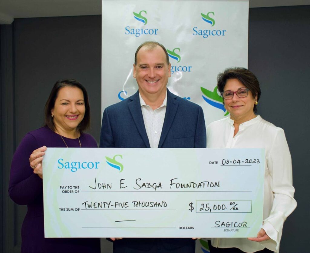 Robert Trestrail, president and CEO, Sagicor Life Inc, Southern Caribbean, centre, presents a cheque to The John E Sabga Foundation for Pancreatic Cancer’s Lisa Ghany, left, operations consultant, and Natalie Sabga, right, founder. - 