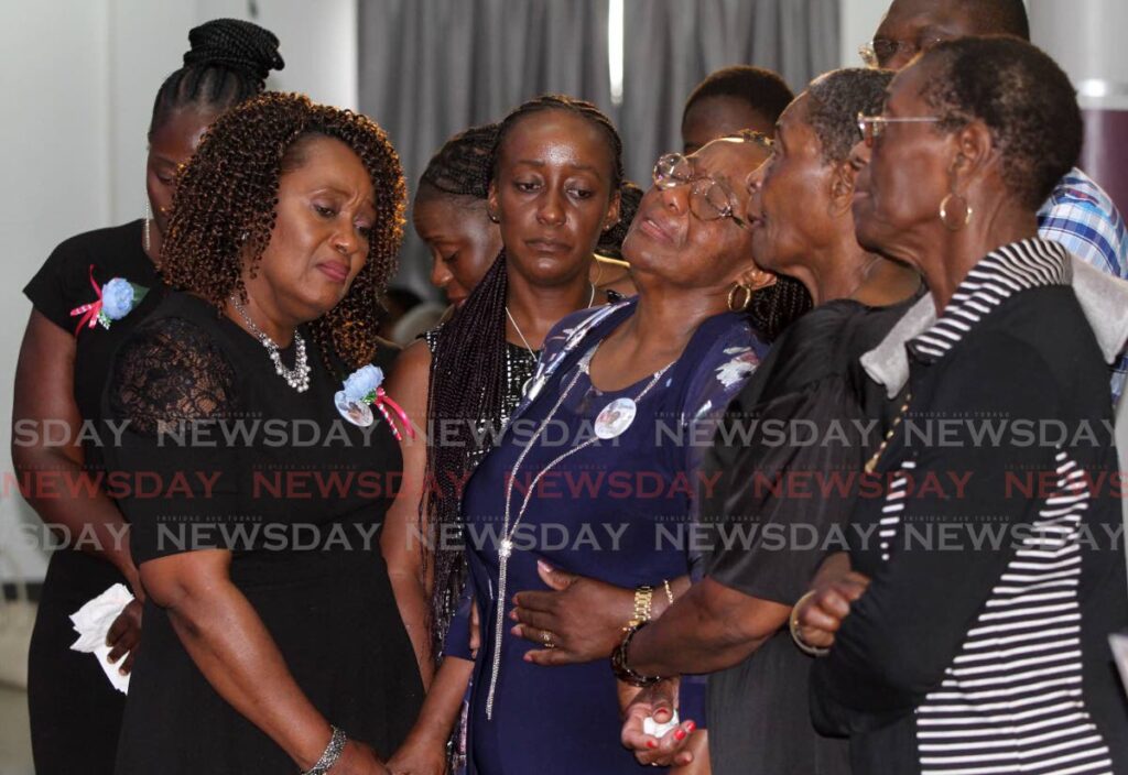 Ruby Shirley Phillip, centre, weeps at the funeral for her daughter Kemba Phillip-Morris and granddaughter Zaya Morris on Thursday at the Open Bible Church in Siparia. Mother and daughter perished in a fire at their home on April 2.  - ANGELO MARCELLE