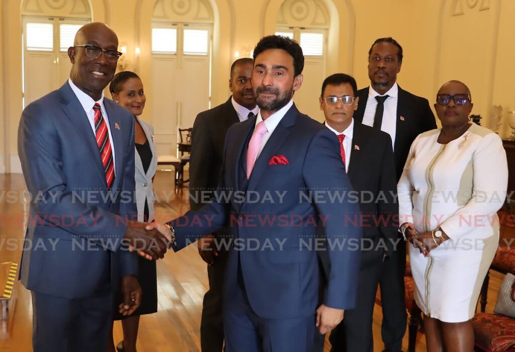 Prime Minister Dr Keith Rowley, left, congratulates new Minister in the Ministry of Works and Transport, Senator Richie Sookhai, after he received his instrument of appointment during a swearing-in ceremony at President's House, Port of Spain, on Friday. - ROGER JACOB